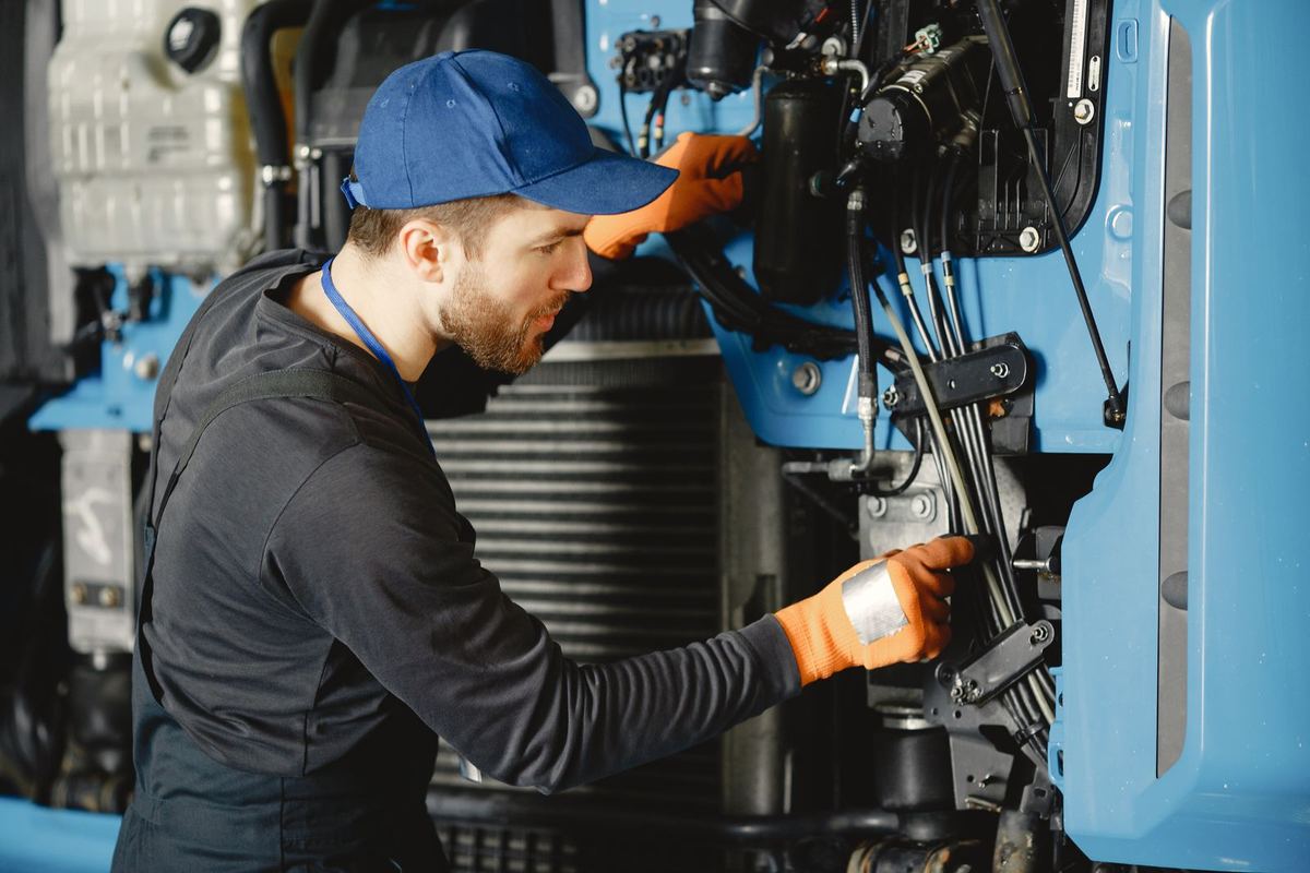 Technician inspecting a truck engine